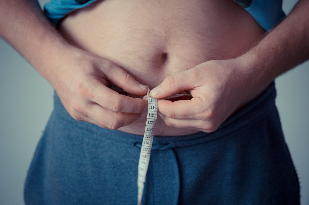Man measure stomach with measuring tape